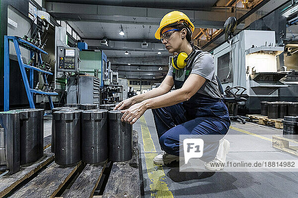 Maintenance engineer wearing hardhat working in modern factory