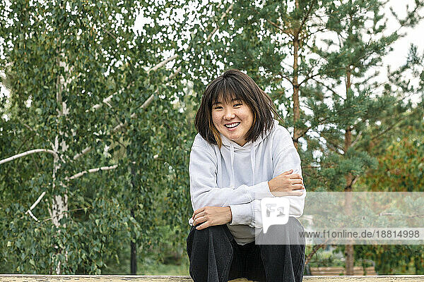 Smiling girl sitting on bench at park