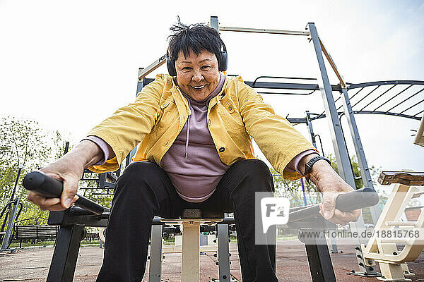 Smiling senior woman working out at park