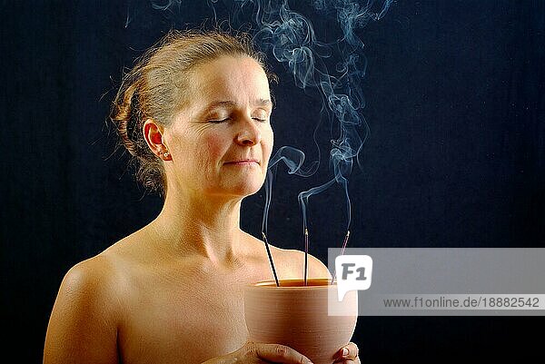 Frau mit Räucherstäbchen  Räucherstäbchen  Geruch  riechen  Aroma  Aromatherapie  Räucherschale