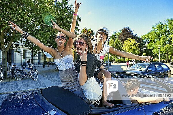 Junge Frauen haben Spaß auf einem Auto in Stockholm Schweden