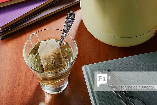 Ein Moment der Entspannung bei einem Glas heißem Tee oder einem anderen Kräutertee  während Sie ein Buch lesen