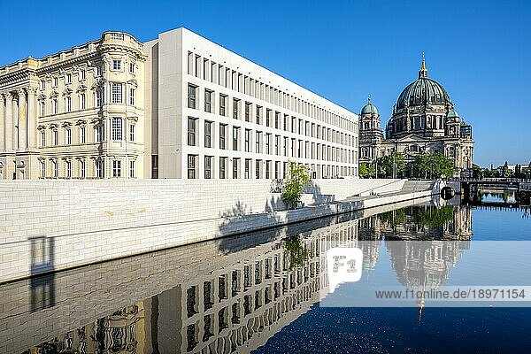 Der Berliner Dom mit dem wiederaufgebauten Stadtschloss spiegelt sich frühmorgens in der Spree
