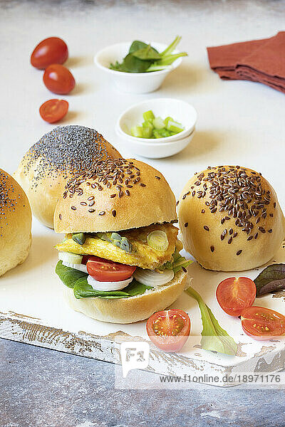 Burger buns with omelette  asparagus spring onions and cherry tomatoes
