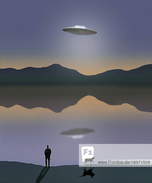 Man looking at flying saucer above lake