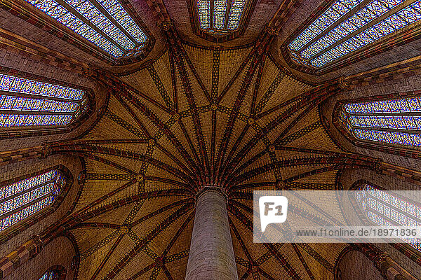 The Church of the Jacobins  a 13th century church  the interior  stained glass windows and view to the ceiling  the palm tree patterns of the roof.