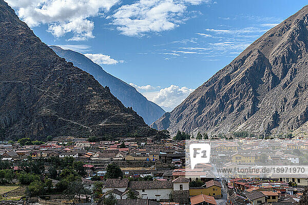 Ollantaytambo  a small town in the mountains  zig zag paths and terraces on the hillside and houses of the town.