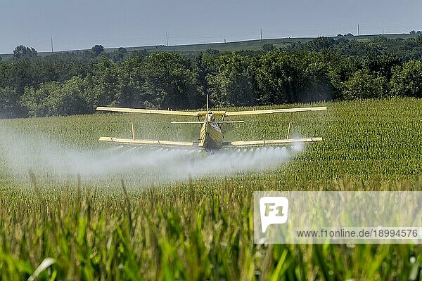 Ein Sprühflugzeug bringt Chemikalien auf einem Feld aus