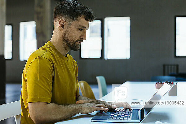 Businessman working on laptop at desk
