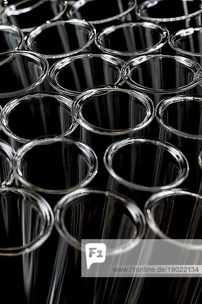 Close up of empty test tubes on black background.