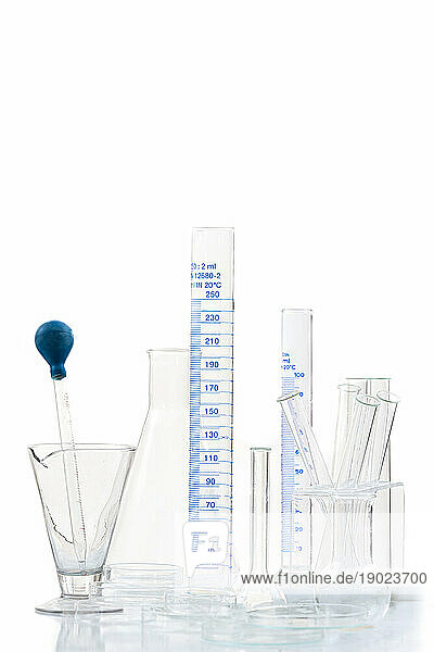 Set of laboratory glassware on plain background.
