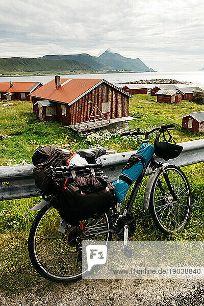 Bicycle parked at the road with a scenic view of red houses and sea