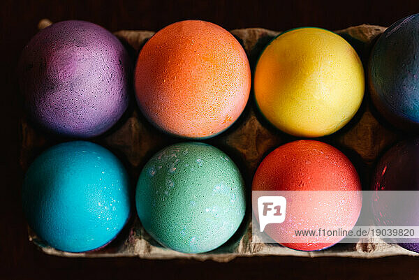 High angle close up of brightly colored Easter eggs.