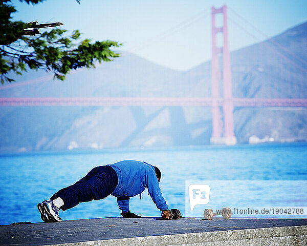 Man doing push-ups outside.