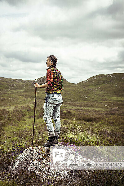 active hiker in sunny Scottish highlands