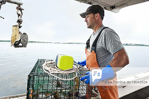Lobsterman readies traps to go back in water in Casco Bay