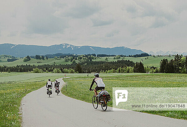 A group of cyclists ride his bikes in Germany seeing The Alps