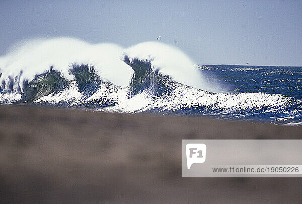 View from shore of consecutive crashing waves in Santa Cruz  California.