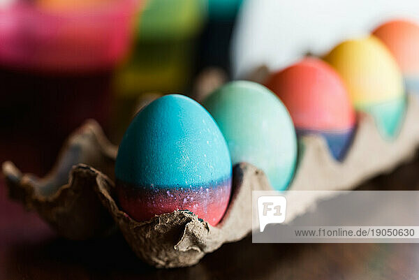 Close up of dyed Easter eggs in bright colors drying in a carton.