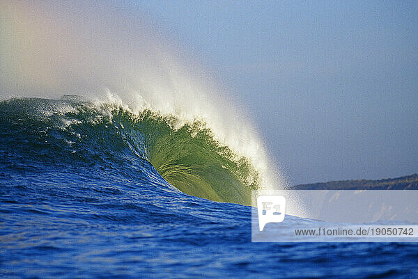 A large blue-green wave crashing at Mavericks  shot from inside the water in Half Moon Bay  California.