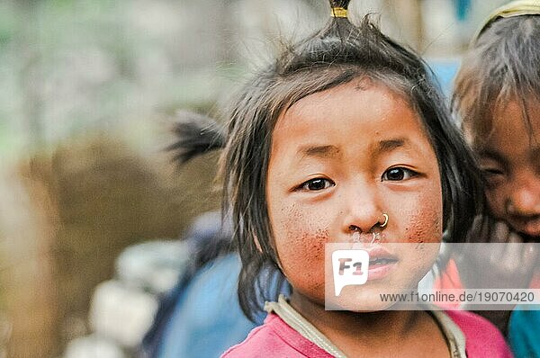 Dolpo  Nepal  ca. Mai 2012: Junges Mädchen mit braunen Augen und braunen Haaren  gekleidet in Rosa  hat ein Nasenpiercing in Dolpo  Nepal. Dokumentarischer Leitartikel  Asien