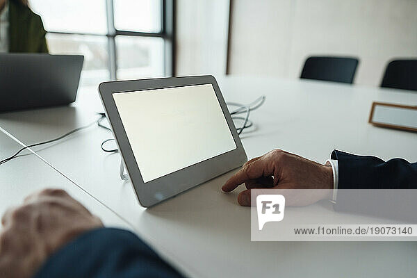 Businessman with tablet PC at desk