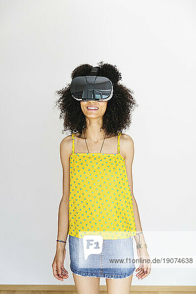 Young woman wearing virtual reality glasses  white background