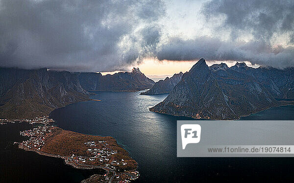 Storm clouds at sunset over majestic mountains along a fjord  aerial view  Reine Bay  Lofoten Islands  Nordland  Norway  Scandinavia  Europe