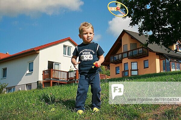 Kleiner Junge spielt mit Propeller-Spielzeug  Sommer