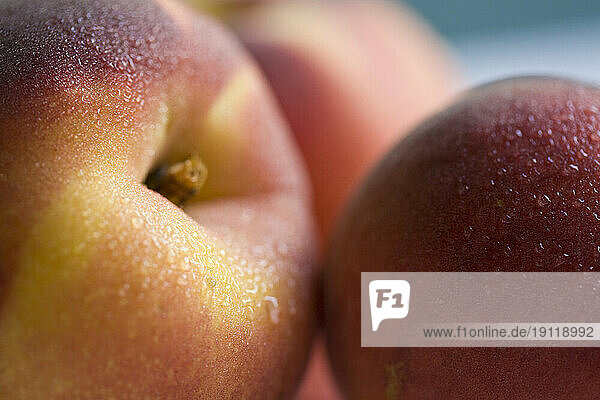 Extreme close up of three peaches