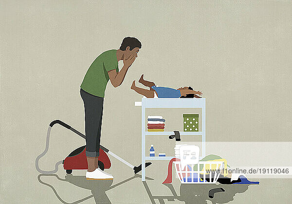 Surprised father taking a break  changing diaper of baby on changing table