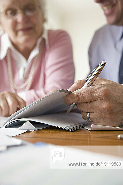 Portrait of a businessman and woman sitting and looking at documents