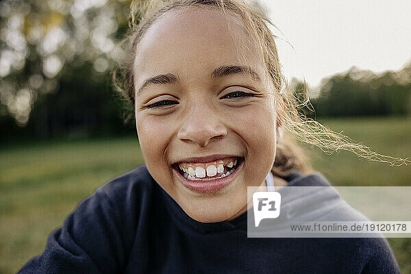 Portrait of happy girl laughing in playground