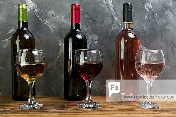 Line wine bottles wineglasses