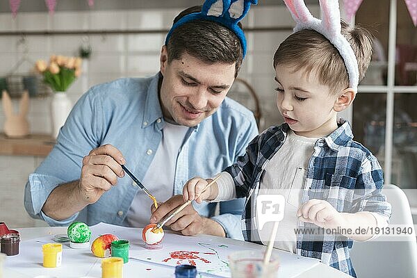 Vater Sohn Malerei Eier Ostern zusammen