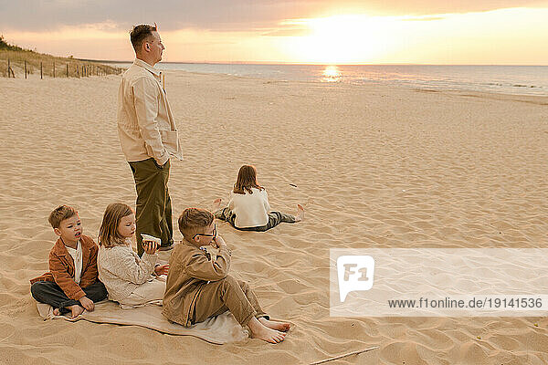 Father with children spending time at beach