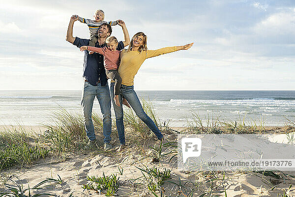 Happy parents enjoying with children at beach