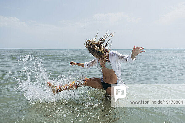 Woman playing in sea water