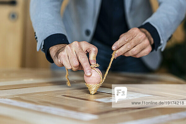 Businessman playing with spinning top on desk
