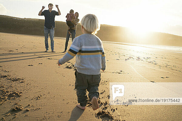 Cheerful family playing together at beach