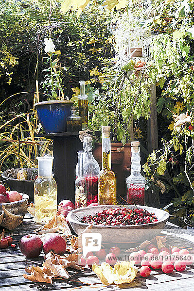 Fruits and various bottled oils on garden table