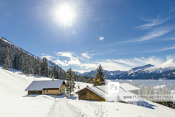 Austria  Vorarlberg  Sun shining over secluded huts in Allgau Alps