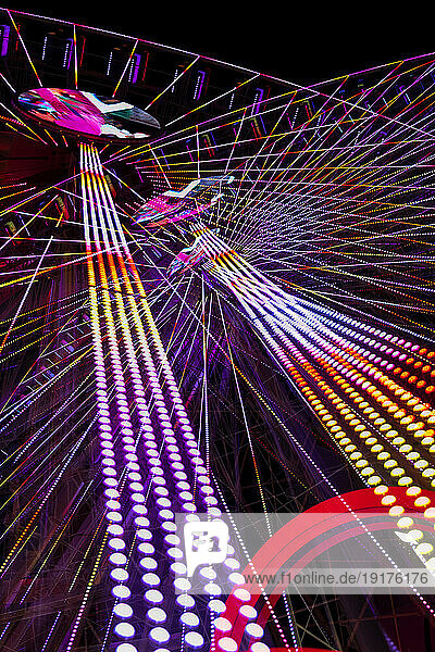 Germany  Bavaria  Wurzburg  Multiple exposure of spinning Ferris wheel at night
