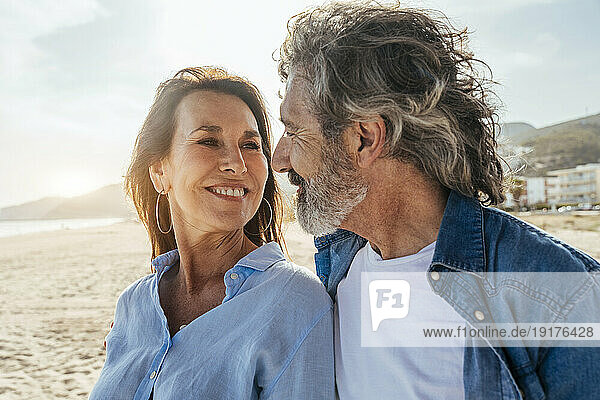 Smiling senior man and woman looking at each other on weekend