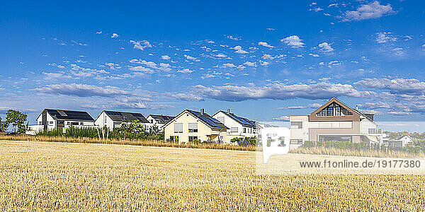 Germany  Baden-Wurttemberg  Waiblingen  Summer field with suburban houses in background
