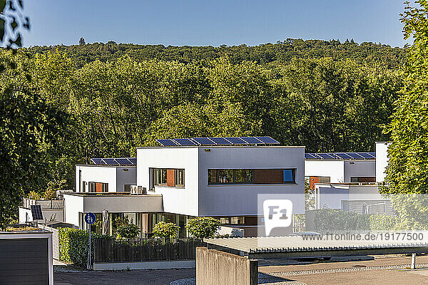 Germany  Baden-Wurttemberg  Esslingen  Modern suburban houses with forested hill in background