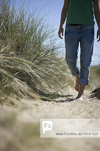 Barefoot young woman walking