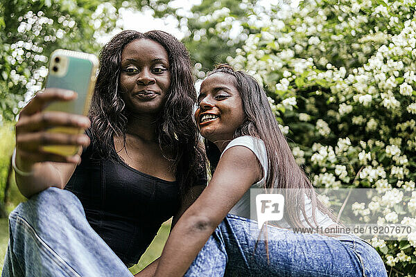 Happy women taking selfie at park