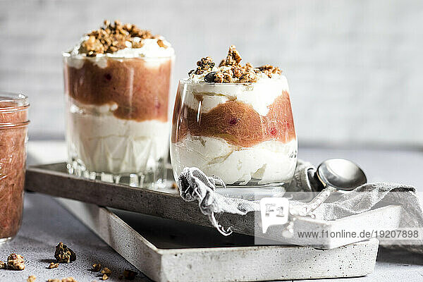 Glasses of healthy sugarfree mascarpone dessert with yogurt  rhubarb and granola
