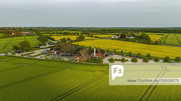 Denmark  Syddanmark  Christiansfeld  Aerial view of village surrounded by summer fields at dusk